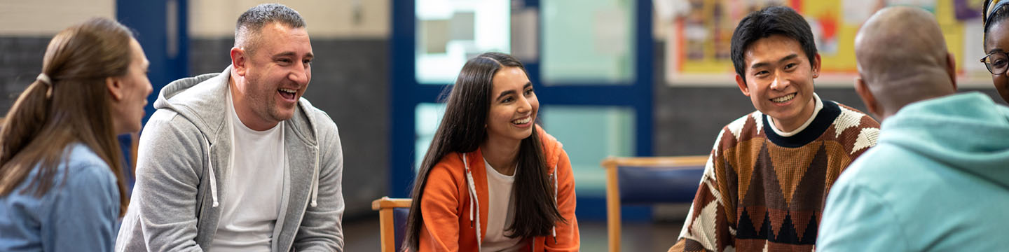A group of people having a discussion in a hospital setting. 